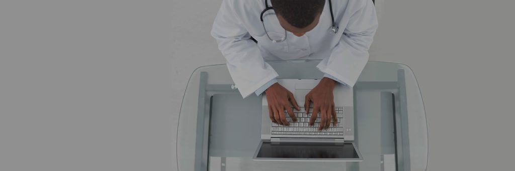 above view of a doctor on a laptop on a standing table